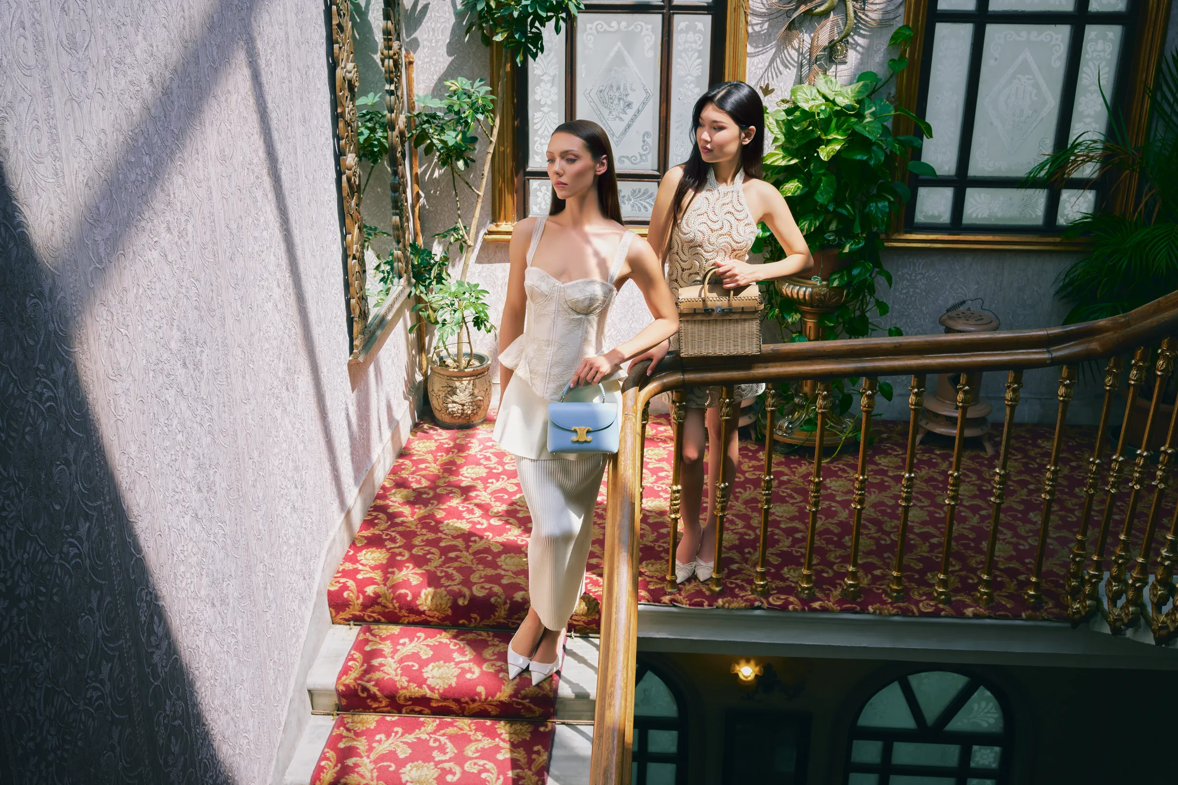 Two guests descending the staircase inside a Rodrigo store